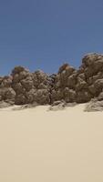 A large rock formation in the middle of a desert video