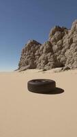 A tire sitting in the middle of a desert video