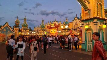 Osaka, Japan on September 30, 2023. Visitors to Universal Studio Japan crowd the Toy Story Mania ride at night. One of the popular games and a must try when you go to USJ. photo