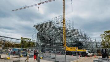 Construction site with scaffolding and crane under cloudy skies, showing urban development in Paris, France, photographed on April 14th, 2024, related to architecture and engineering photo