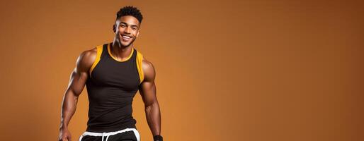 Cheerful African American athlete smiling in sportswear against a warm brown background, embodying health and fitness, perfect for New Year resolutions and gym promotions photo