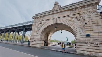 turista explorador el histórico Pont Delaware bir hakeim adornado con esculturas terminado el jábega río en París, Francia, en un nublado primavera día, abril 14, 2024 foto