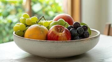 A ceramic fruit bowl with a thick rim and smooth finish perfect for holding a bountiful display of ripe fruits. photo