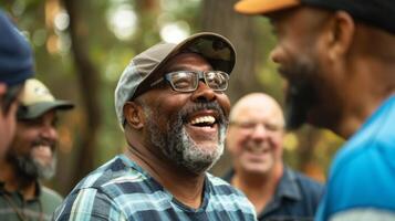 A group of men laughing and bonding while partaking in a teambuilding challenge at a mens healing retreat photo