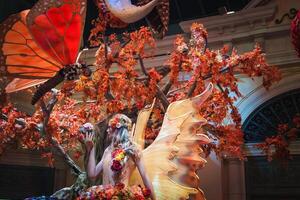 Whimsical fairy figure with golden wings in enchanted indoor display, Las Vegas. photo