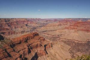 Grand Canyon, Arizona Panoramic view of vibrant canyon walls under clear blue sky photo