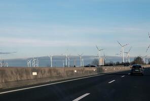 Austria, road to Vienna from Bratislava - 01.14.2024 Wind farm park next to a road in Austria in sunny weather photo