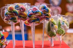 Great choice of colorful caramel on stick and spiral shaped candy for sale in shop window at German Christmas Market. Berlin, Nuremberg, Munich, Hamburg, Fulda. Xmas, Easter market in Germany. photo