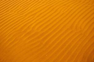 Seamless wet sand with sea water on a whole background. Empty wavy sandy sea bottom. Exotic Sandy Ocean beach surface. Top view. Simple, minimalistic photo. Ideal concept for banner, poster, ads. photo