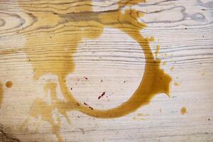 Coffee stains on white wooden table. Wood texture background. Big dark brown dramatic Splatter, fleck, splash, spot, drops of black coffee. Pattern, wallpaper. Top view. Closeup. Copy space. photo