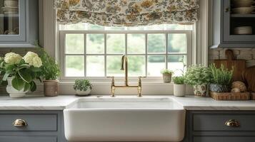 A vintageinspired bridge faucet in a polished br finish draws attention to an apron front sink in a charming cottage kitchen giving a charming nod to the past photo