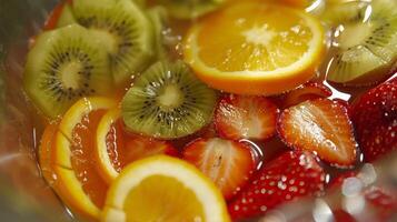 A variety of fruits including oranges strawberries and kiwis being sliced and added to the sangria pitcher photo