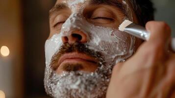 Using a facial brush he applies a nourishing and hydrating mask leaving it on for 10 minutes photo