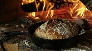 Amidst the flickering flames a loaf of dough rises in a cast iron pan transforming into a delicious and hearty bread perfect for a fireside meal photo