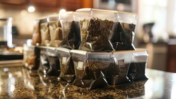 A stack of recently filled tea bags sit on the counter ready to be used for the mans herbal tea blends photo
