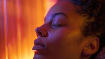 A closeup of a persons face in the sauna their expression serene as they use the heat to go deeper into their meditative practice. photo