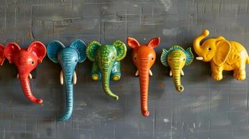 A set of colorful ceramic coat hooks each one shaped like a different animal and painted with bright eyecatching hues. photo