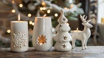 A trio of ceramic candle holders each shaped like a different holiday icon a snowflake a reindeer and a Christmas tree. photo