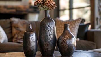 A trio of ceramic vases with a metallic finish adding a touch of modern elegance to any space. photo