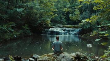 The sound of birds chirping and a distant waterfall provide a calming soundtrack for the mans reflections photo