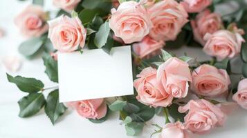 mockup of a white card beside pink rose bouquet, soft pastel tones photo