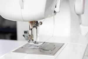 Modern sewing machine presser foot closeup, macro photo