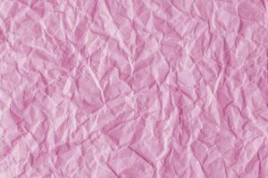 Recycled crumpled pink paper texture background photo