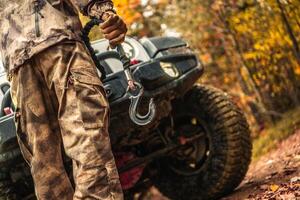 Driver Preparing Wrench Hook For the Car Recovery During Off Road Muddy Drive photo