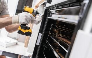 Home Appliances Technician Installing a Stove photo