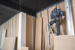 Caucasian Electrician Contractor Installing Electric Cable photo