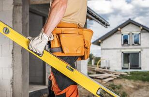 Construction Worker with a Spirit Level in His Hand photo