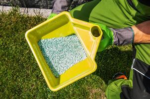 Garden Taker Fertilizing Residential Grass Area photo