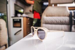 Sunglasses Left on a Table Inside Modern RV Camper Van photo