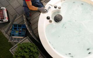 Professional Garden SPA Worker Servicing Modern Hot Tub photo