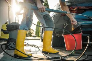 Washing a Car Using Pressure Washing Machine photo