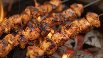A fiery fusion of flavors in a zesty chicken tikka skewer grilled to perfection over a bed of hot coals photo