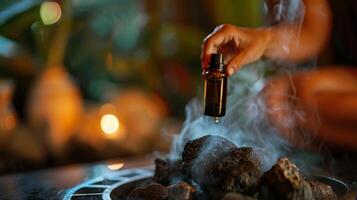 A woman pours eucalyptus oil onto hot sauna rocks filling the air with a refreshing and invigorating scent to complement the postyoga detoxification process. photo