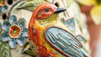 Keep your feathered friends happy with a ceramic bird feeder designed with intricate details and bright colors. photo