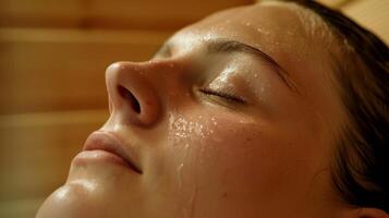 A closeup of a persons face fully relaxed while receiving an aromatherapy massage inside the sauna. photo