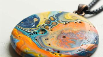 A pendant showcasing a marbling effect created by mixing different shades of clay together. photo