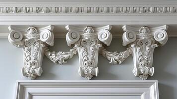 A detailed view of delicate molding and trim work above a doorway adding a touch of elegance to an otherwise plain wall photo