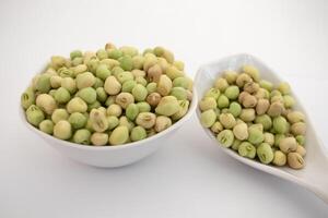 Fresh Green black eyed peas beans in a white bowl on white background photo