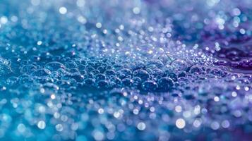 The water is sprinkled with small round bath salts in shades of blue and purple photo