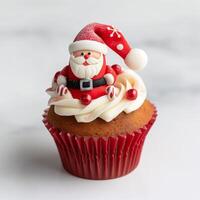 Festive Christmas Cupcake with Santa Claus Topper on White Background photo