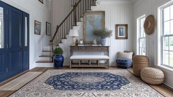 A chic entryway with a patterned rug and a console table decorated with a mix of family photos and unique sculptures