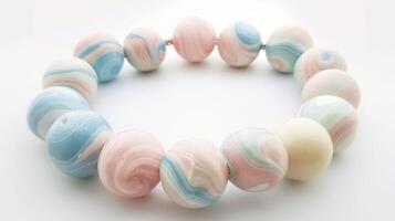 A piece of jewelry made with marbled clay beads in soft pastel colors. photo