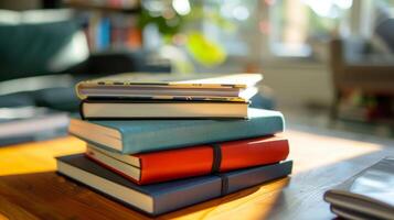 A stack of journals and notebooks on a coffee table used by members to reflect and track their personal development journey photo