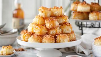 A tower of decadent coconut macaroons filled with a creamy pineapple curd and finished with a drizzle of caramel sauce photo