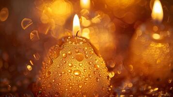 The golden hues of candlelight reflect off the tearshaped droplets of scented essential oils used in the soapmaking process photo