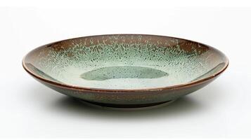A small plate with a unique drop glaze effect in shades of green and brown resembling a peaceful forest landscape. photo